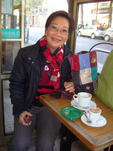 A woman (Trần Thị Thủy Ngọc) seated and smiling in a coffee shop