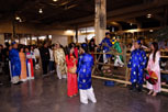 A girl wearing the traditional vietnamese Ao Dai red dress talking to a boy in a blue and white costume