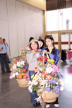 Two women holding baskets of flowers
